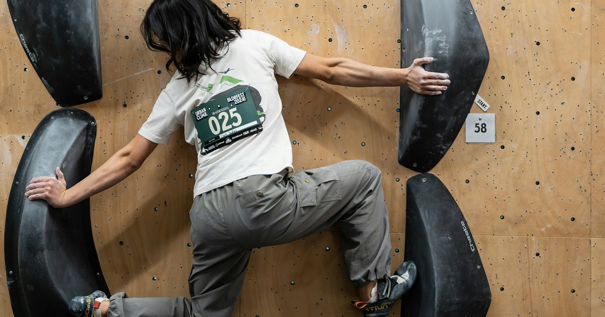 ボルダリングジムでクライミング中の女性クライマー